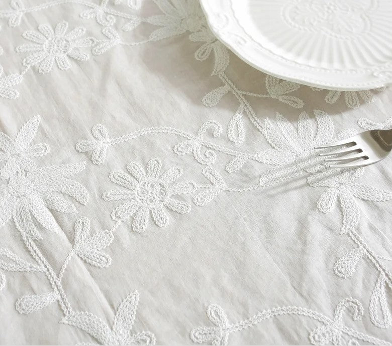 White embroidered tablecloth with large ruffle