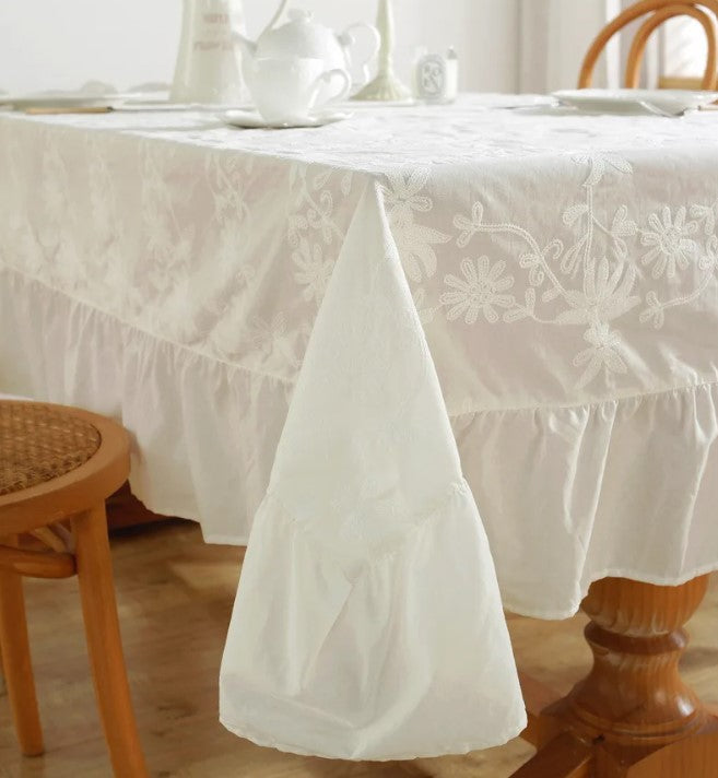 White embroidered tablecloth with large ruffle