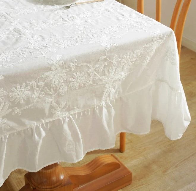 White embroidered tablecloth with large ruffle