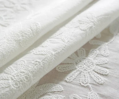 White embroidered tablecloth with large ruffle