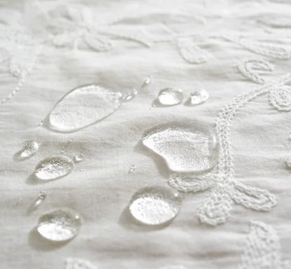 White embroidered tablecloth with large ruffle